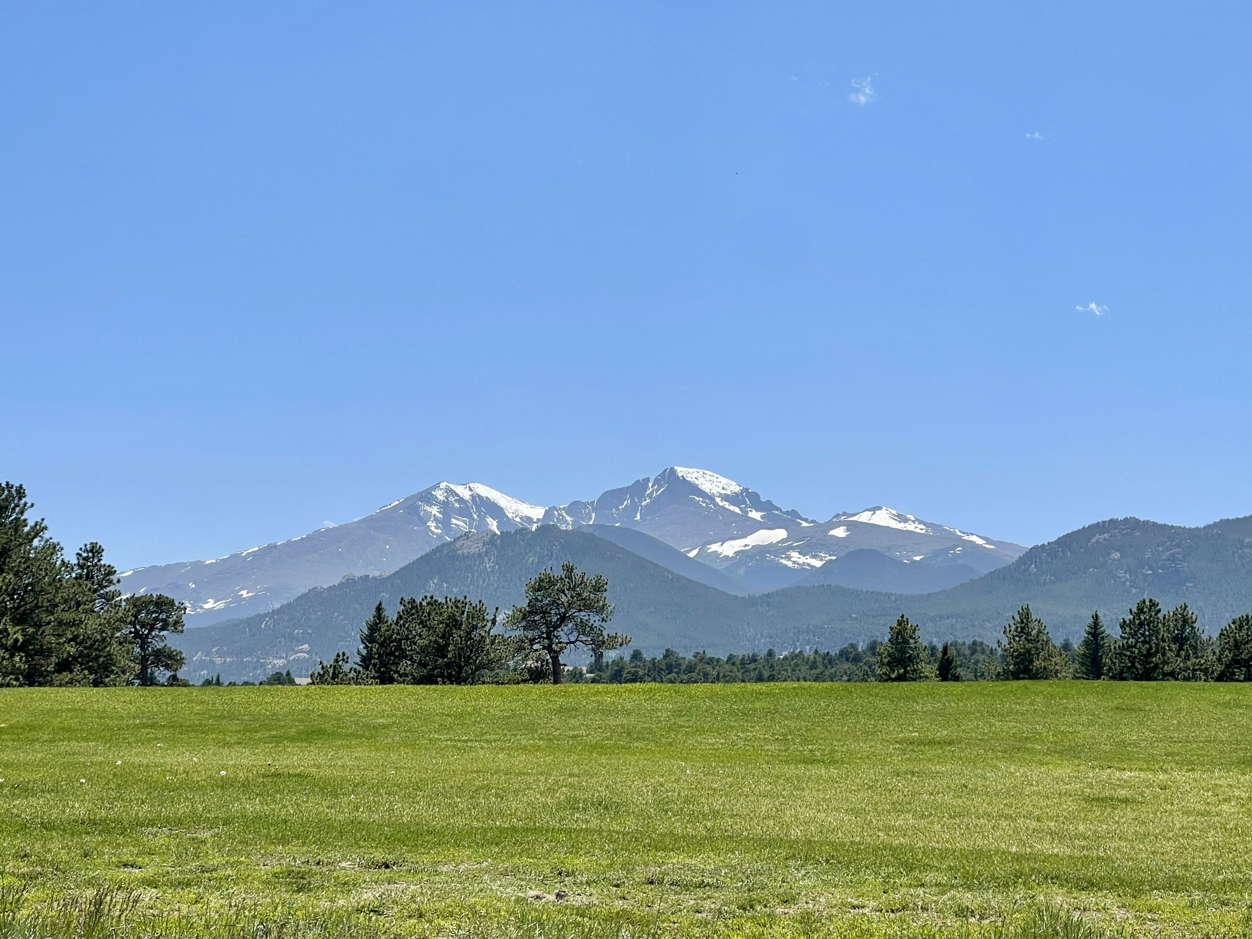 Estes Park mountain living - snow-capped peaks and meadow